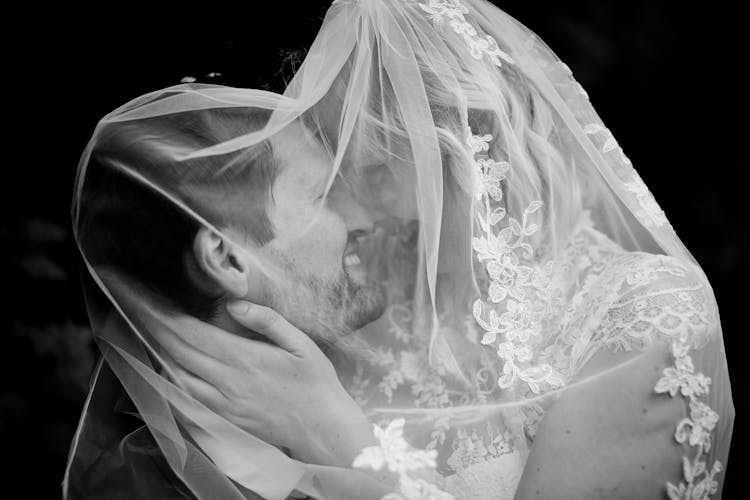 Newlywed Couple Cuddling On Black Background