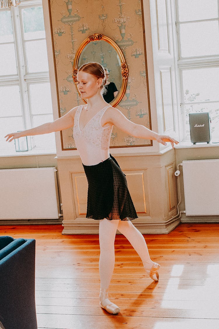 Young Ballerina Dancing In Bright Room