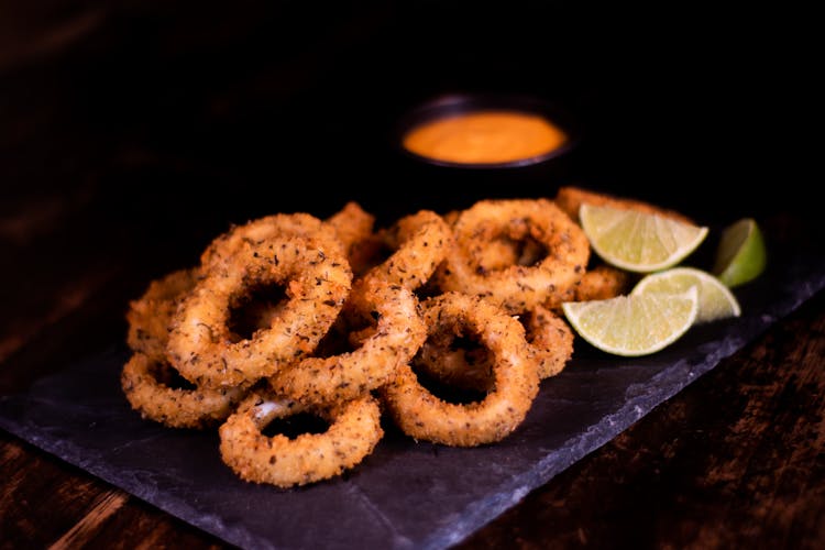 Fried Onion Rings And Slices Of Lime