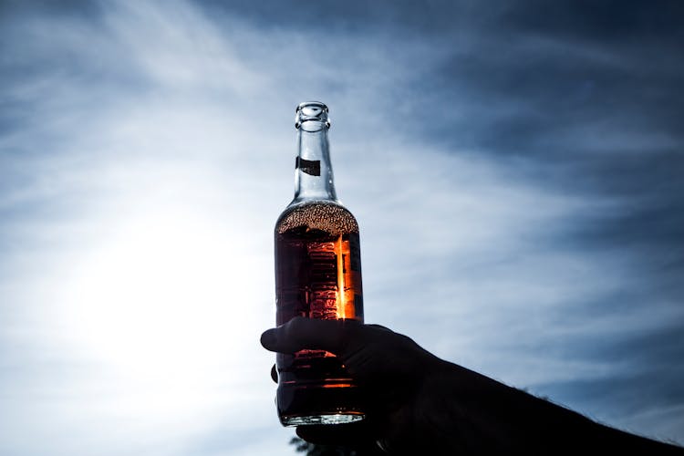 Person Holding Beer Glass Bottle