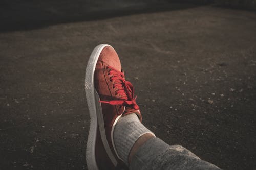 Free Person Wearing Red Puma Sneaker Stock Photo