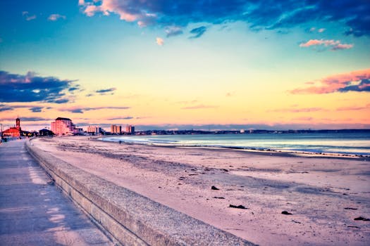 A tranquil sunset view at Revere Beach, showcasing colorful skies and serene waters.