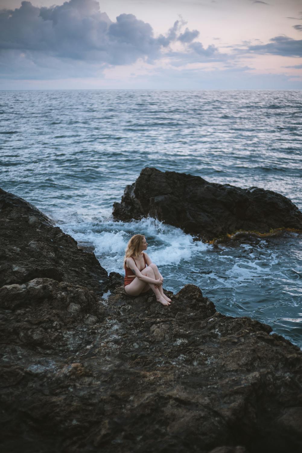 Woman in White Bikini Lying on Rocky Shore · Free Stock Photo