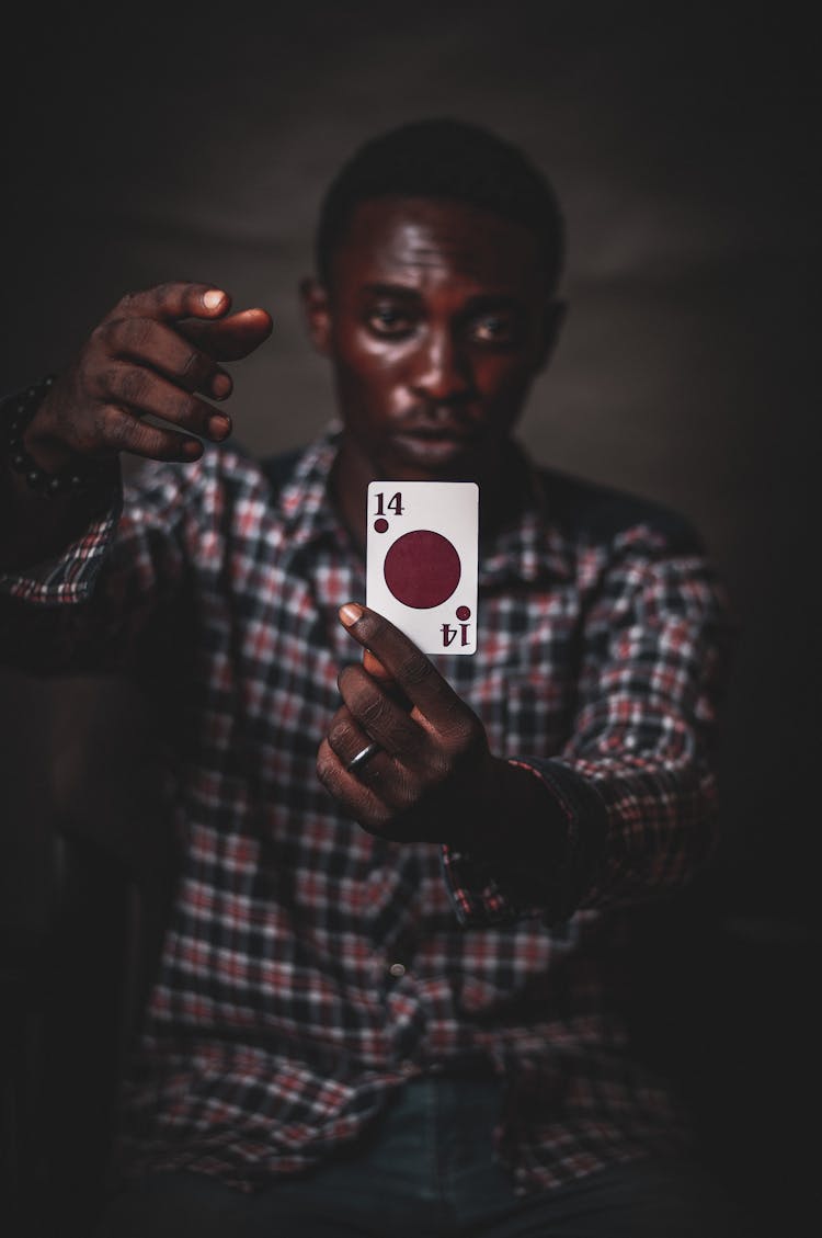 Serious Black Man Showing Playing Card