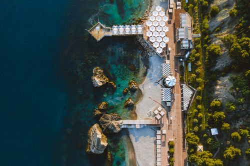 Free Stunning aerial shot of a coastal resort in Berehove, Ukraine, showcasing clear waters and a serene beach ambiance. Stock Photo