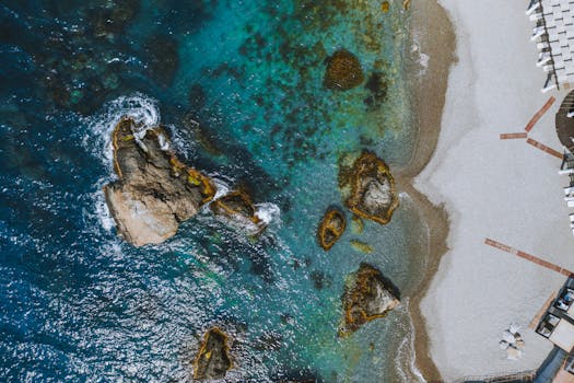 Stunning aerial view of a rocky shore and azure waters along Berehove beach.