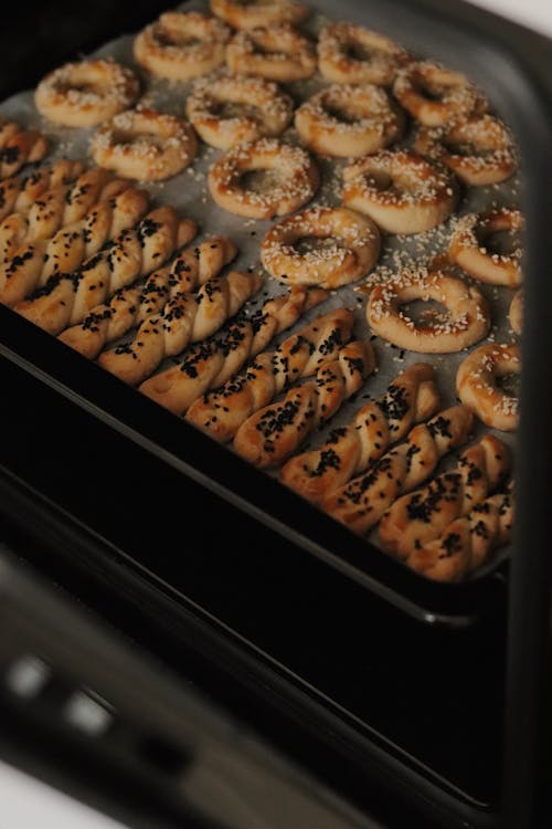 Free Tasty crispy pastries on tray in oven Stock Photo
