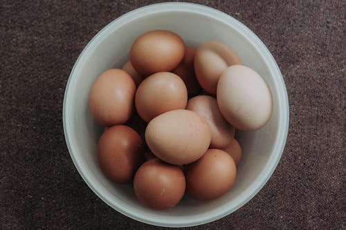 Close-Up Photo of Pile of Brown Eggs in a Bowl