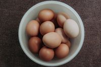 Brown organic eggs piled in a white bowl — photo by Rio Lecatompessy on Pexels