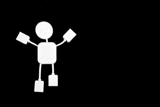 A white figurine made of cables depicted on a stark black background, showcasing minimalist design.