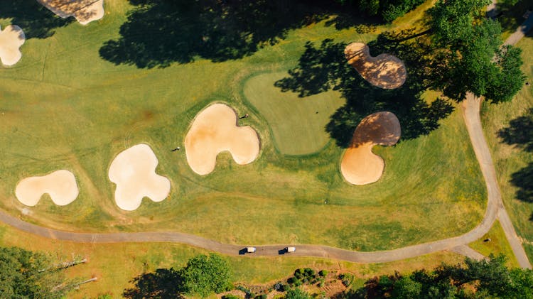 Green Golf Course With Bunkers Near Wavy Road