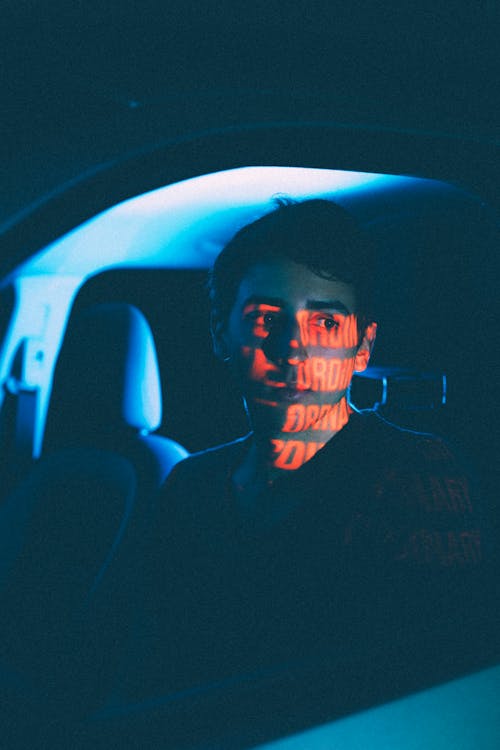 Dreamy man in car with shadow on face