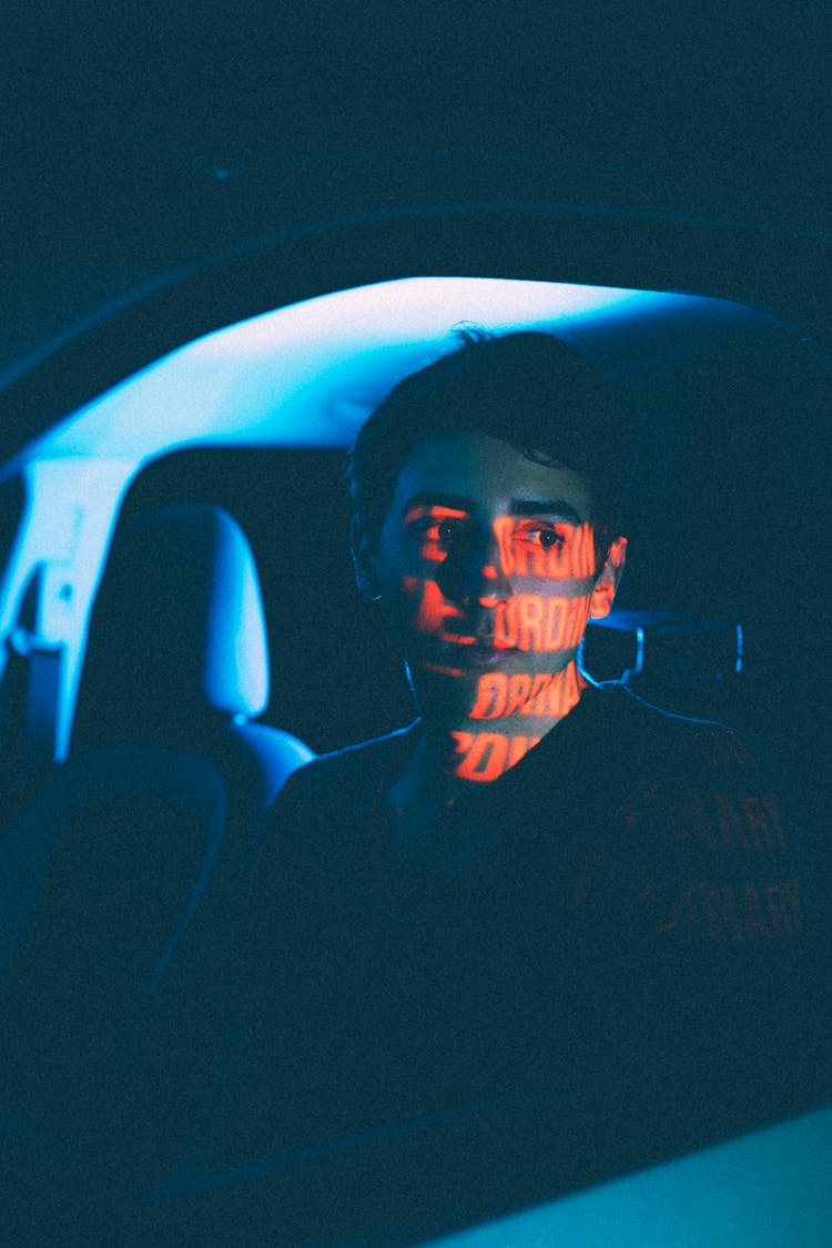 Dreamy Man In Car With Shadow On Face