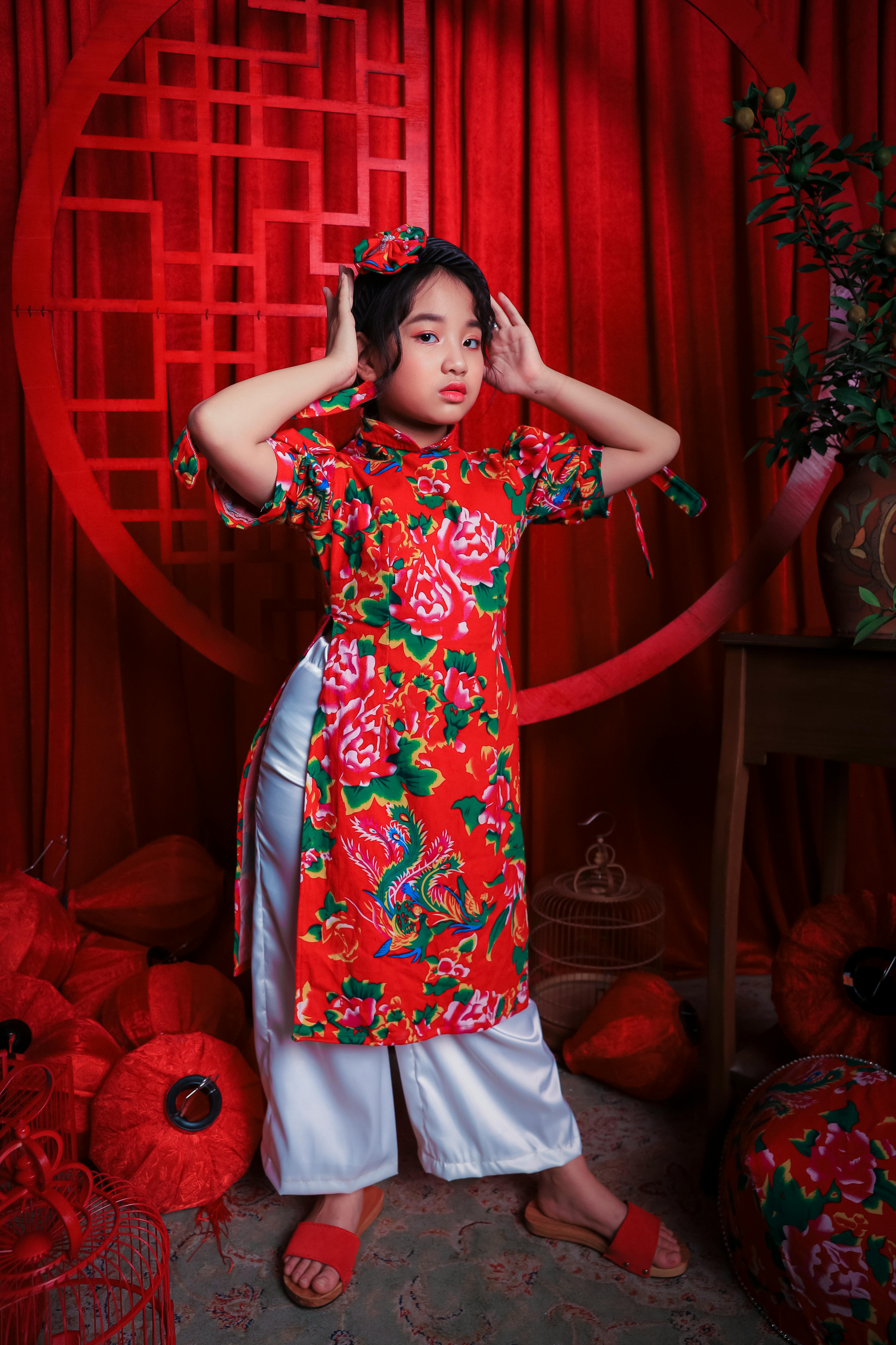 stylish asian kid in colorful traditional clothes