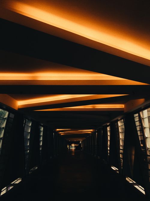Free Explore a modern indoor walkway with striking neon lighting and architecture. Stock Photo
