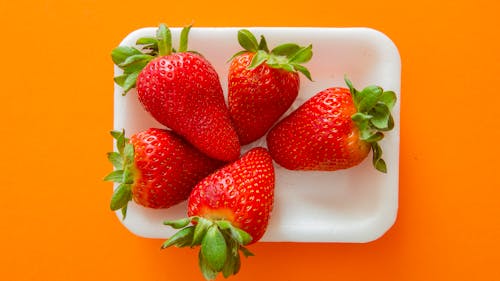 Free Strawberry Tray on Orange Background Stock Photo