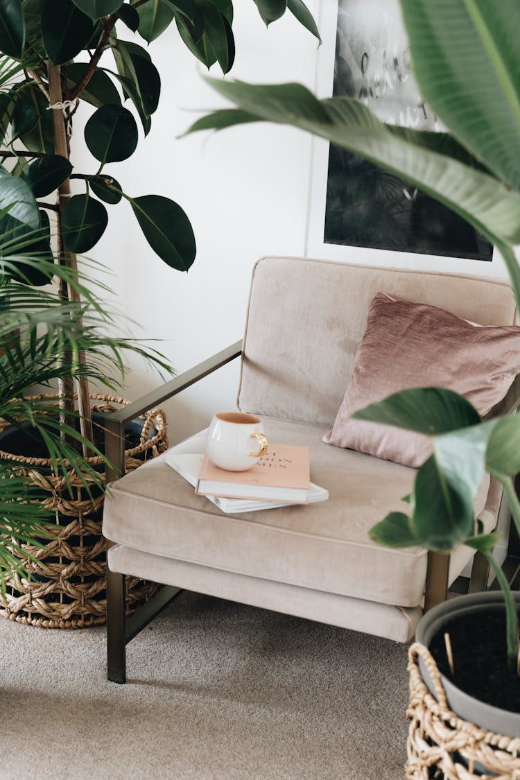 Books And A Cup Over An Arm Chair