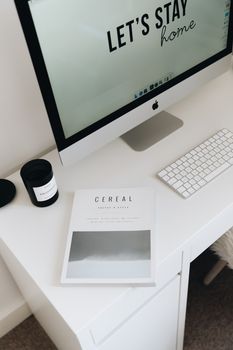 A neatly organized modern home office desk featuring a computer and stylish decor.