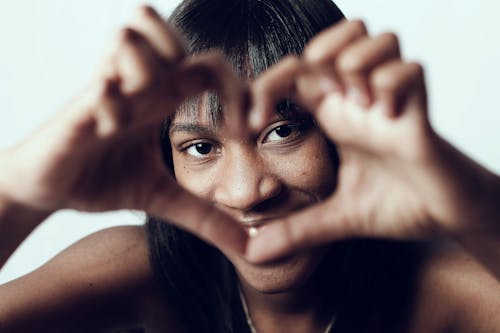 A Woman Flashing the Love Sign