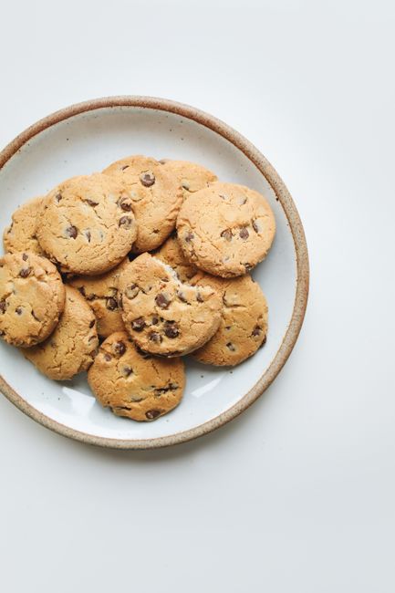 Tasty chocolate chip cookies arranged on a ceramic plate for a delightful snack.