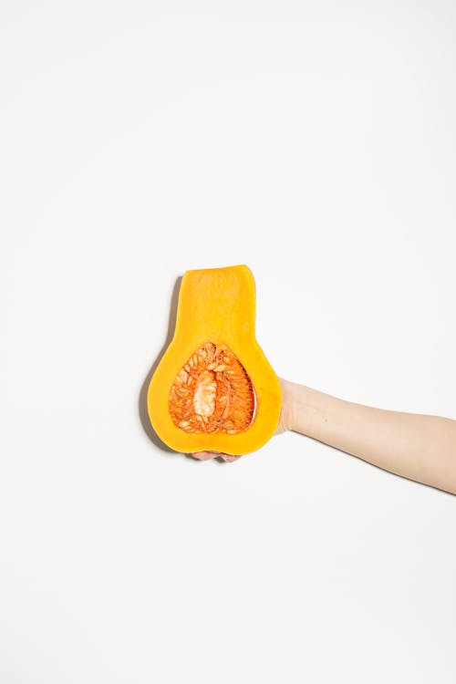 Free Hand Holding Cut Pumpkin Stock Photo