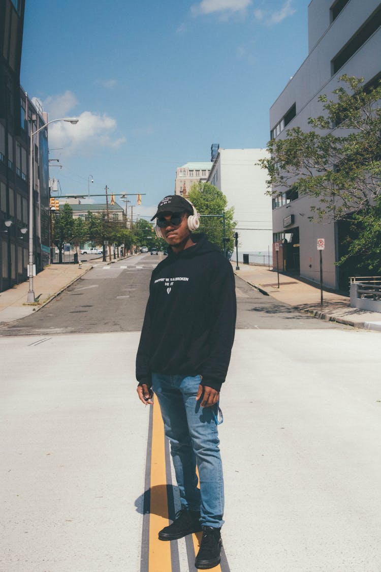 Stylish African American Guy In Headphones On Road