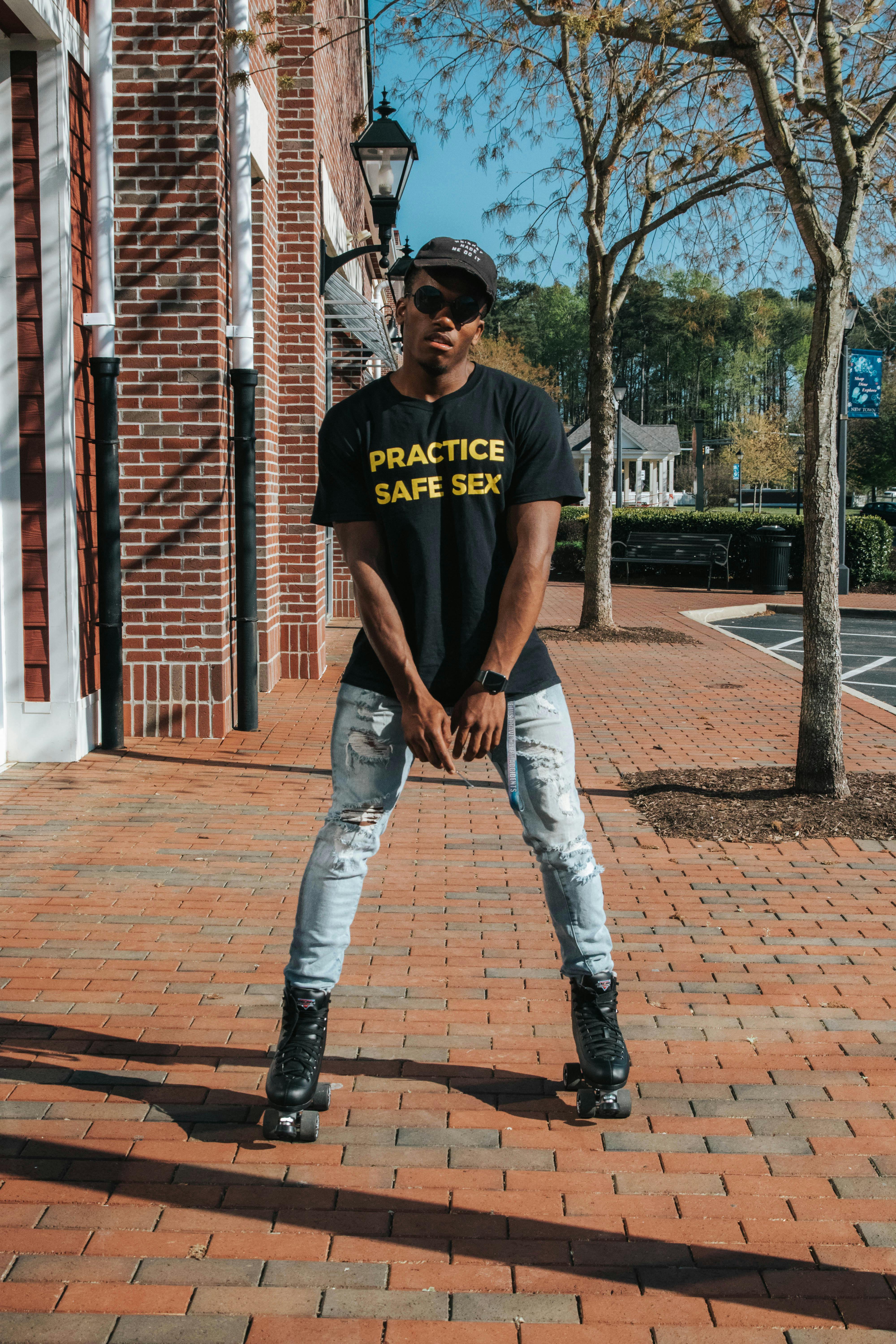 stylish black man in cap and sunglasses on street