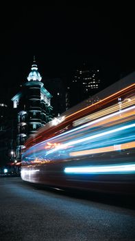 Captivating cityscape with vibrant light trails and illuminated architecture in San Francisco at night.