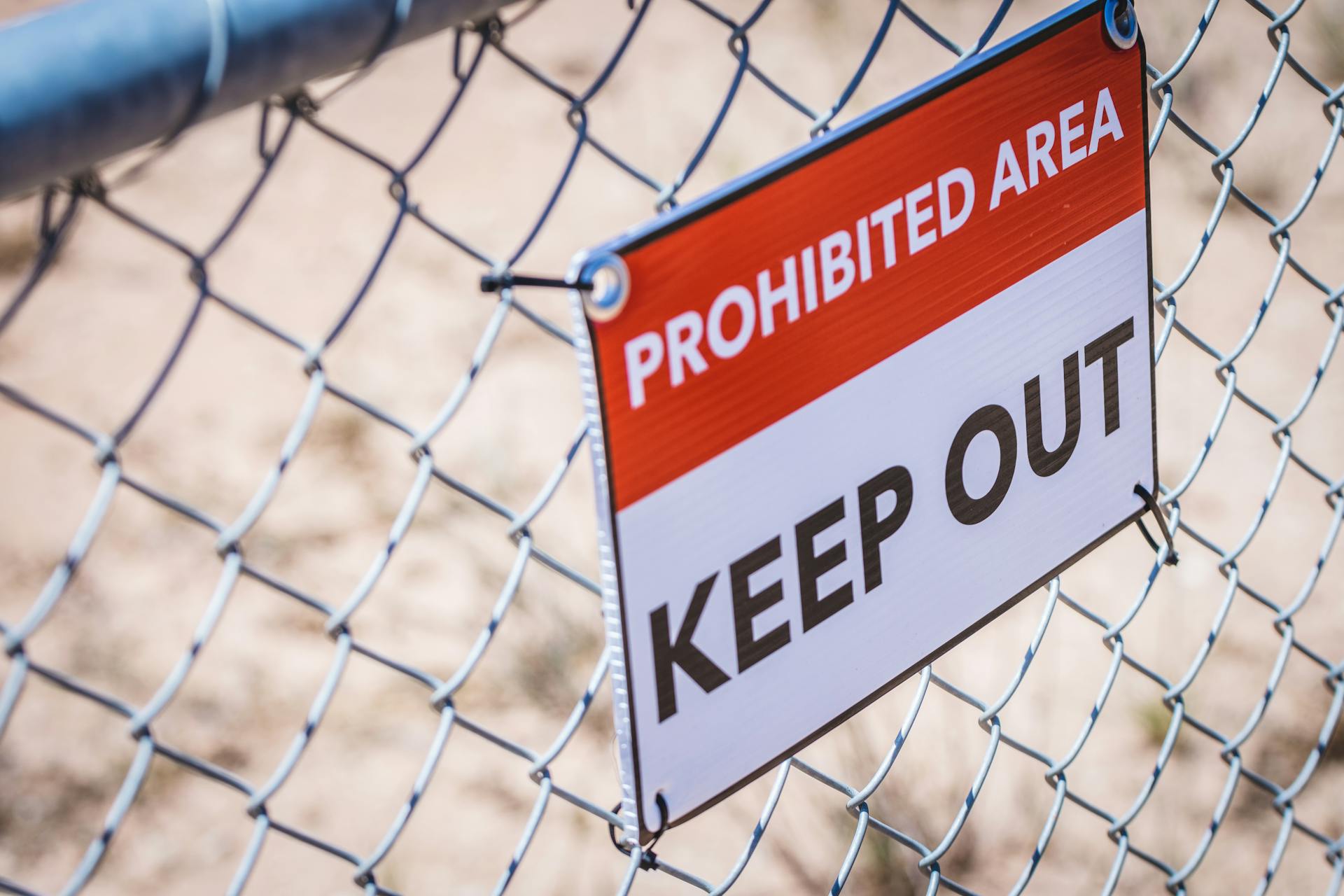 Warning Sign on Wire Fence