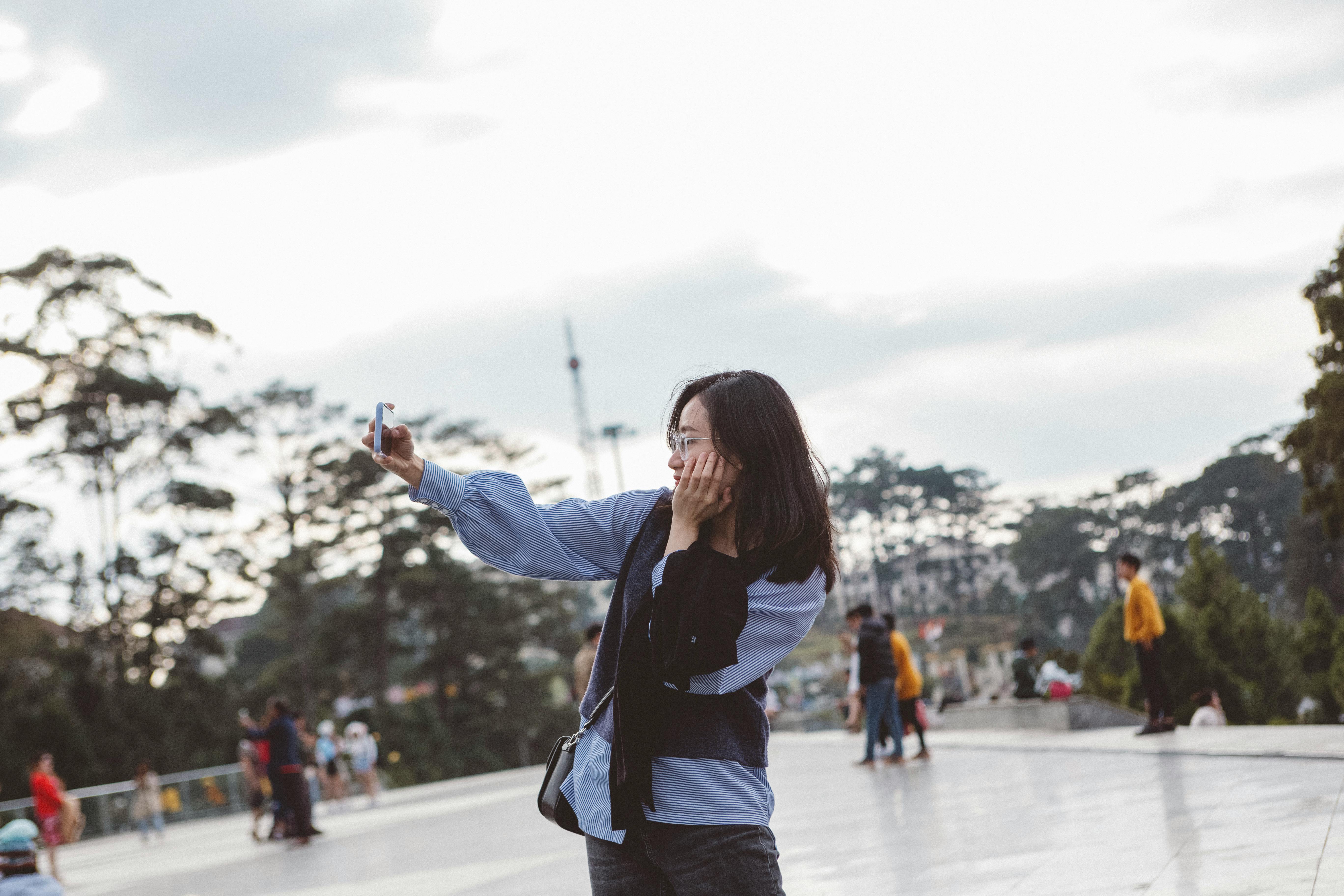 Woman Blue Jacket taking a Selfie · Free Stock Photo