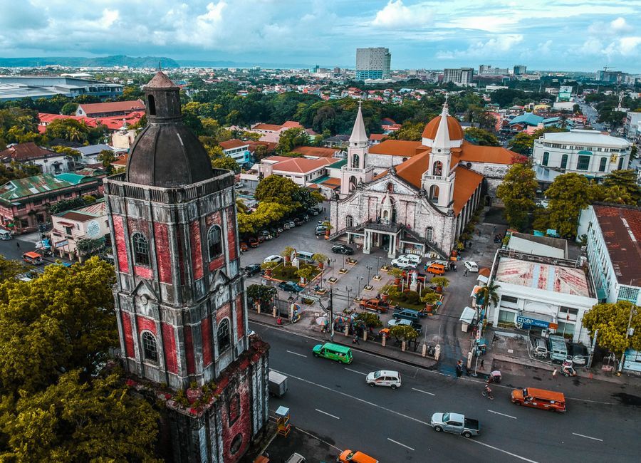 Stunning drone shot capturing Jaro Cathedral and surrounding urban landscape in Iloilo City, Philippines.