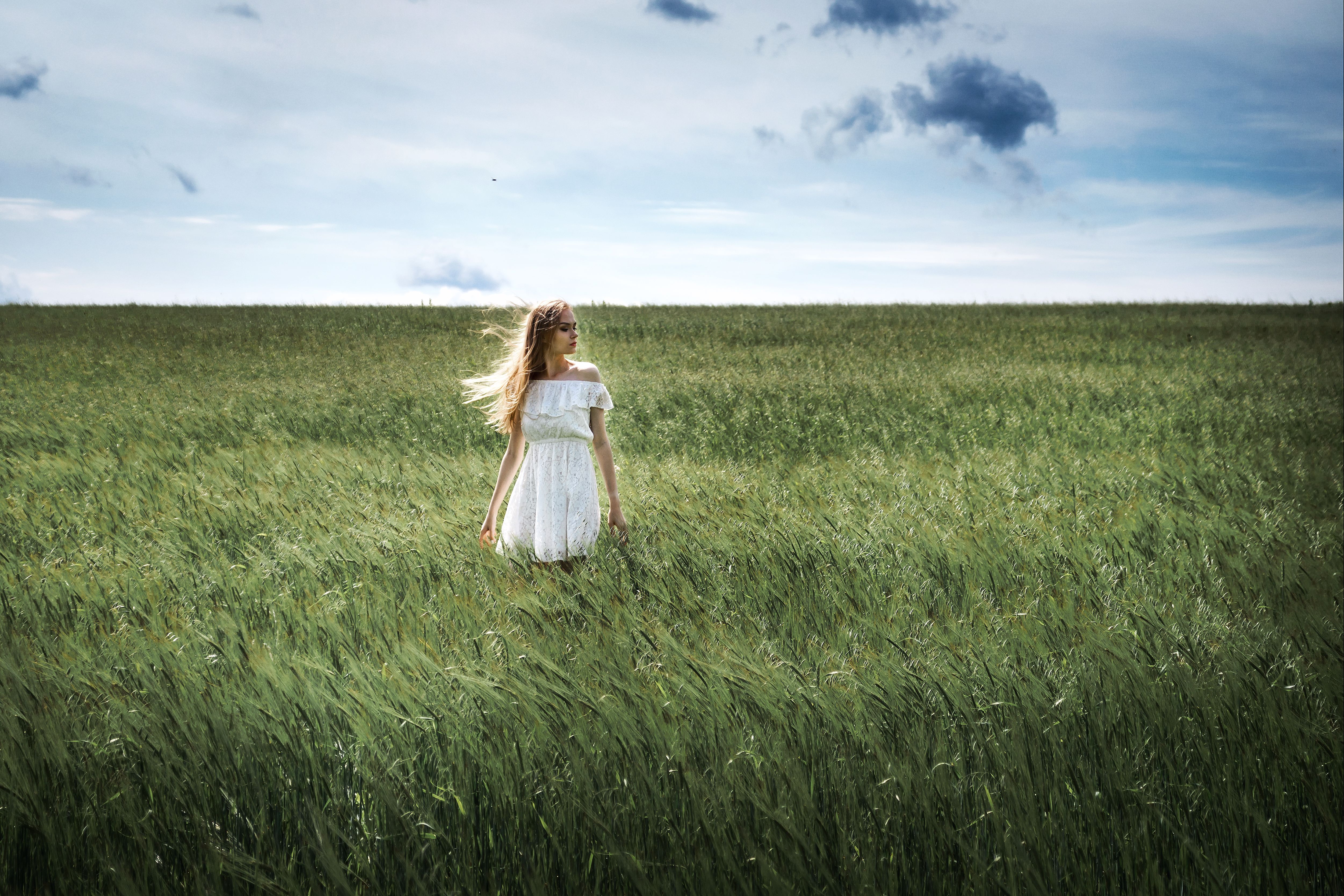 Woman in White Dress standing in a green Grass Field · Free Stock Photo