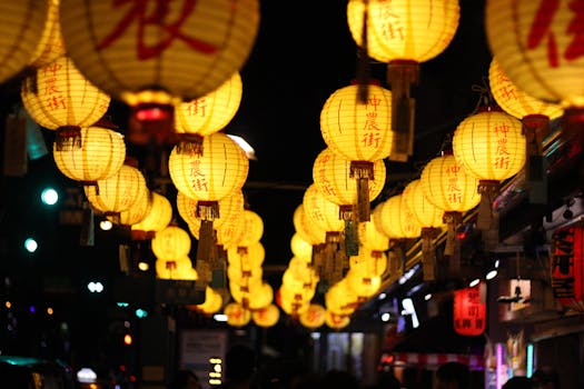 Hanging Chinese lanterns light up the night at a vibrant Taiwan street market.