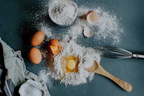Free Flour and broken eggs on table before dough kneading Stock Photo