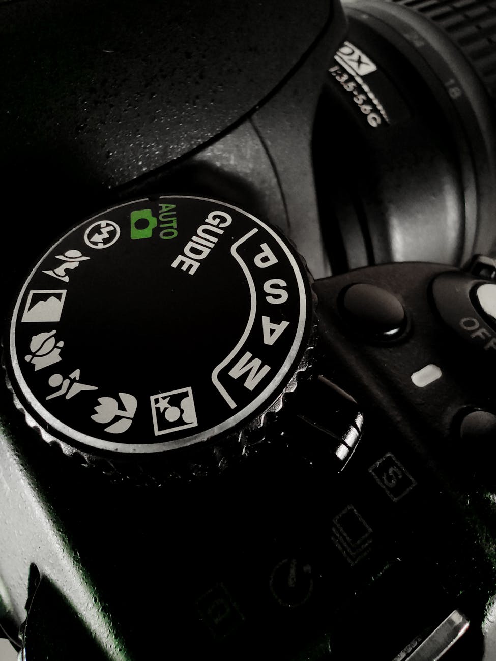 Detailed shot of a DSLR camera mode dial showing various settings and modes.