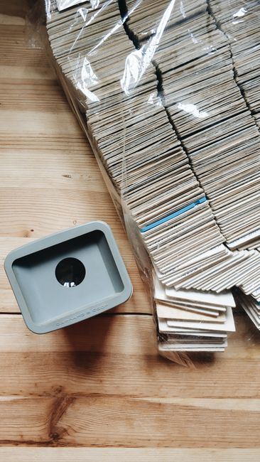 A large collection of film slides stacked on a wooden surface, showcasing a retro photography style.