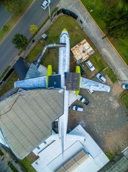 Stunning aerial view of an aircraft on display, surrounded by roads and buildings in Cuenca, Ecuador.