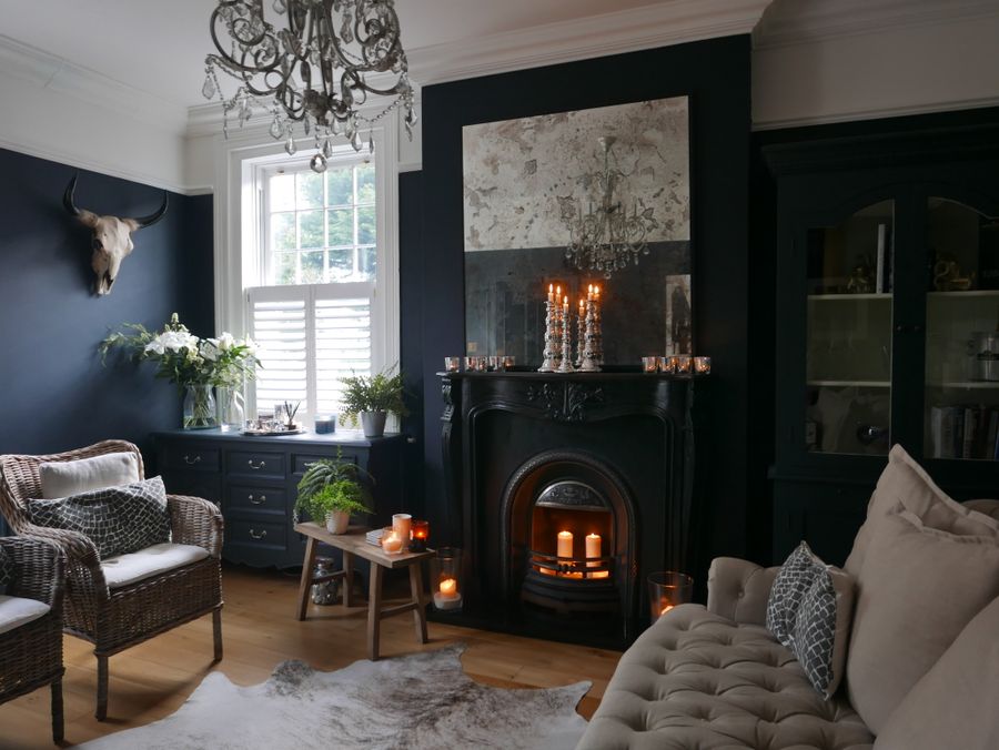 Elegant living room with a dark fireplace, designed and executed by De Legacy