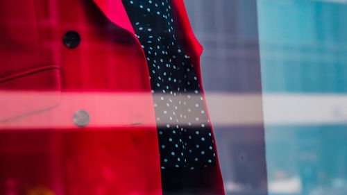Free Through glass of elegant blouse and red blazer on mannequin in fashion boutique Stock Photo