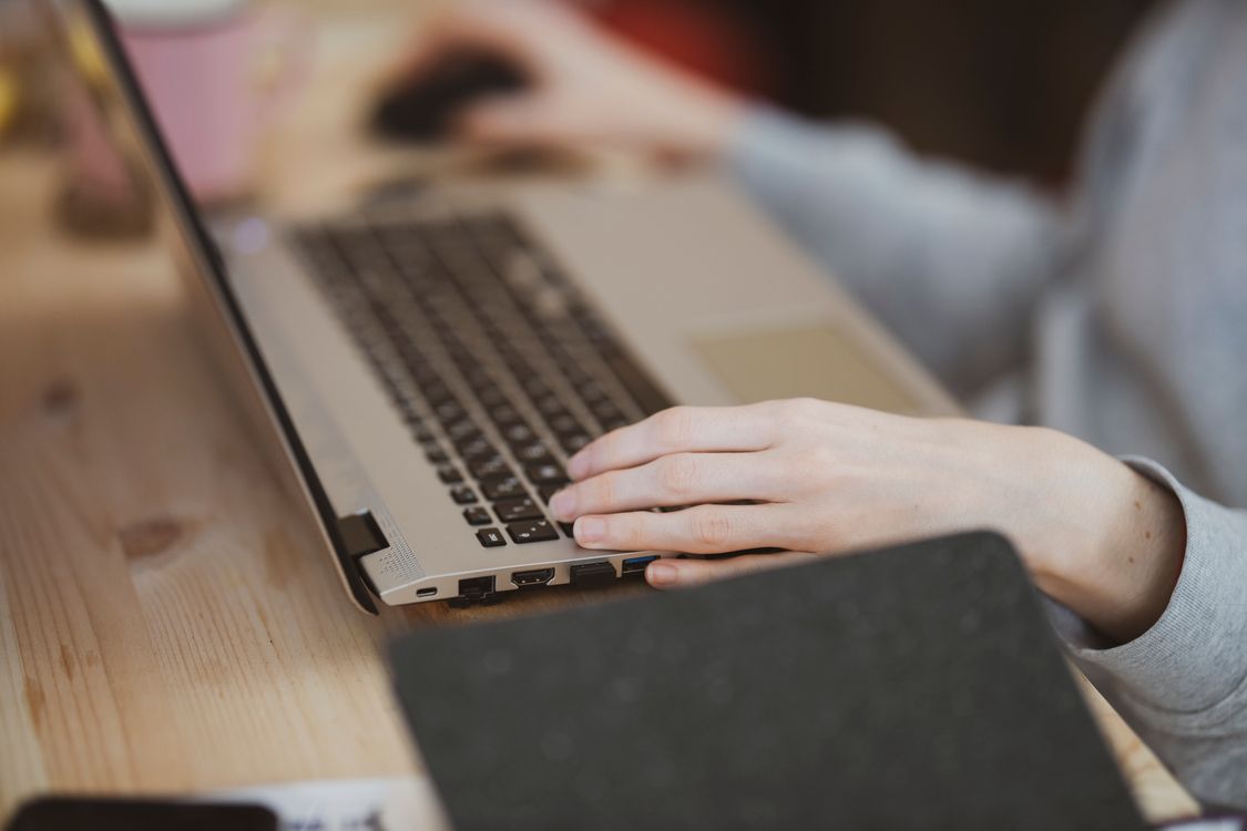 Person's Hand on a Laptop Β· Free Stock Photo