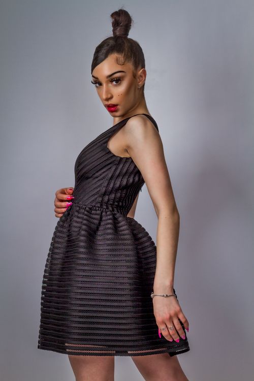 Free Elegant woman posing in a black dress, showcasing modern fashion in New York. Stock Photo