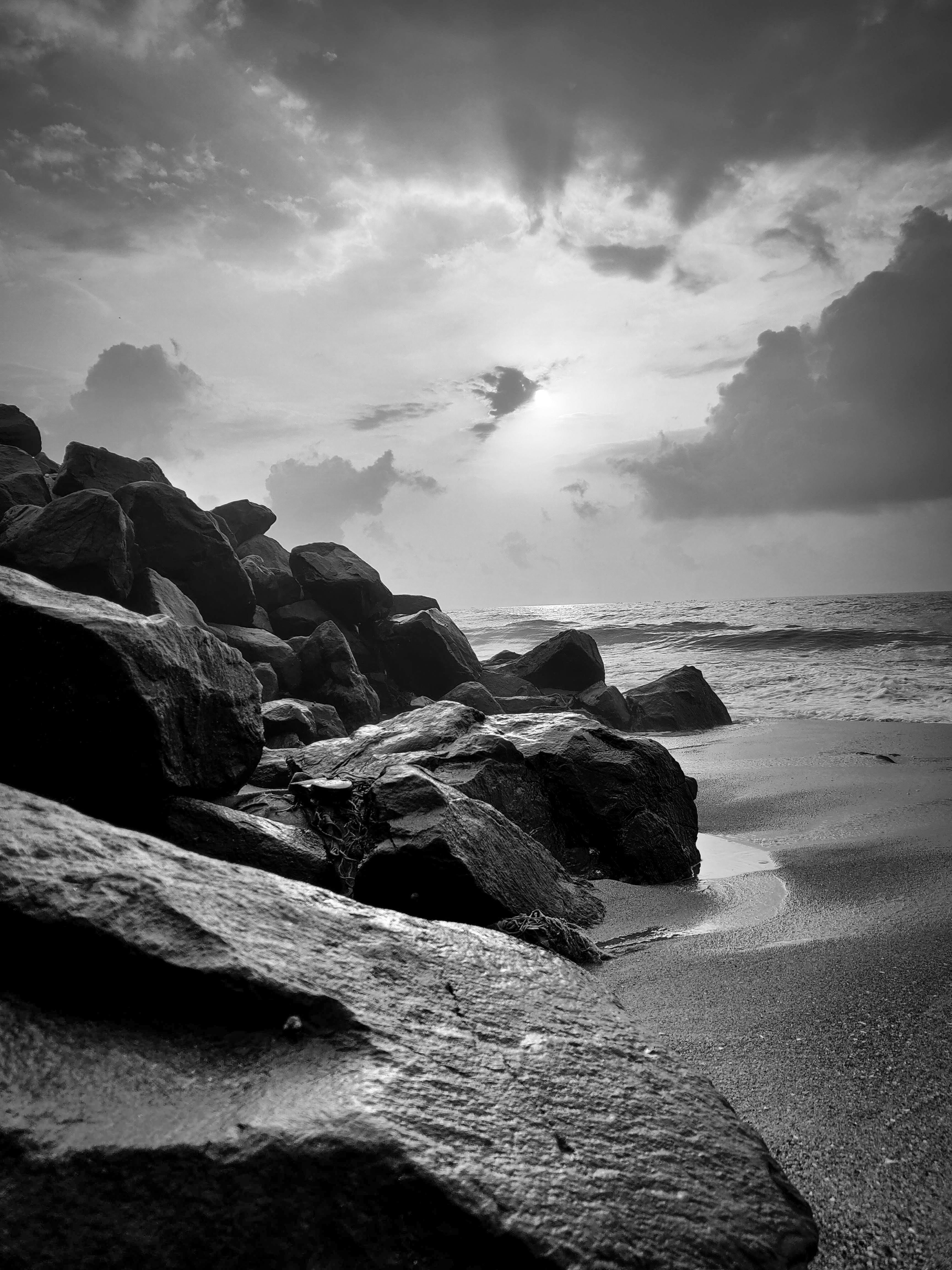 A captivating black and white photo of rocky shoreline under a dramatic sky in TN, India.
