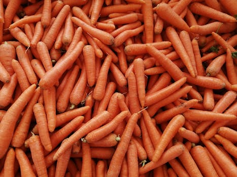 A vibrant heap of fresh organic carrots at a market in Istanbul, Turkey.