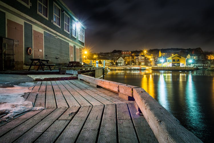 Wooden Embankment Of Bay In Village At Night