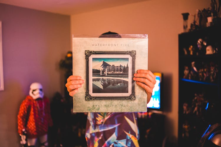 Faceless Person Showing Package For Vinyl Disk