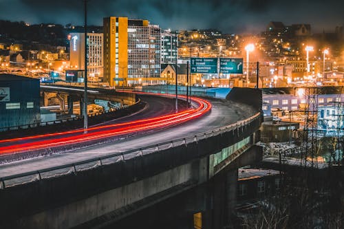 Traffic on paved night road on bridge in city