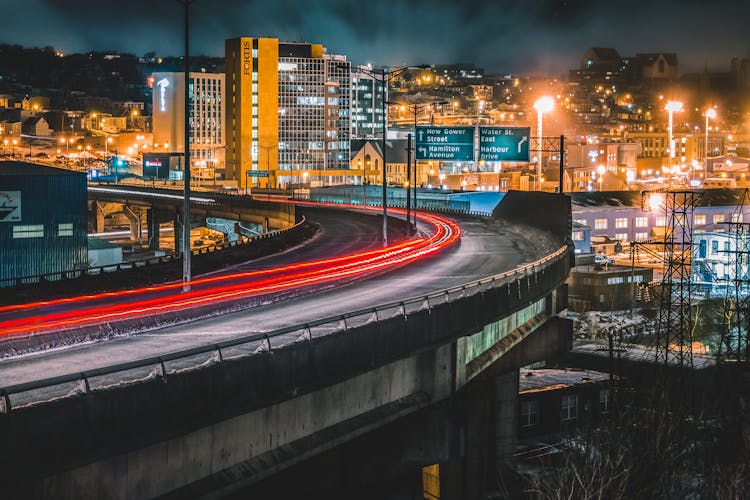 Traffic On Paved Night Road On Bridge In City