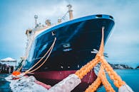 Big ship moored to shore with rope