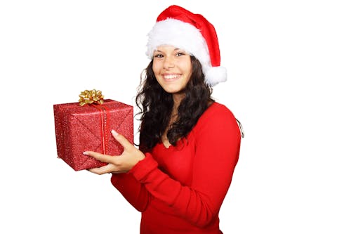 Smiling Woman in Red Long Sleeve Shirt Holding Red Gift Box