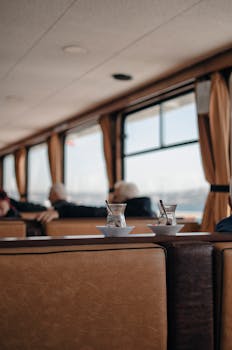 Relaxing view with tea glasses on a ship, perfect for a tranquil journey.